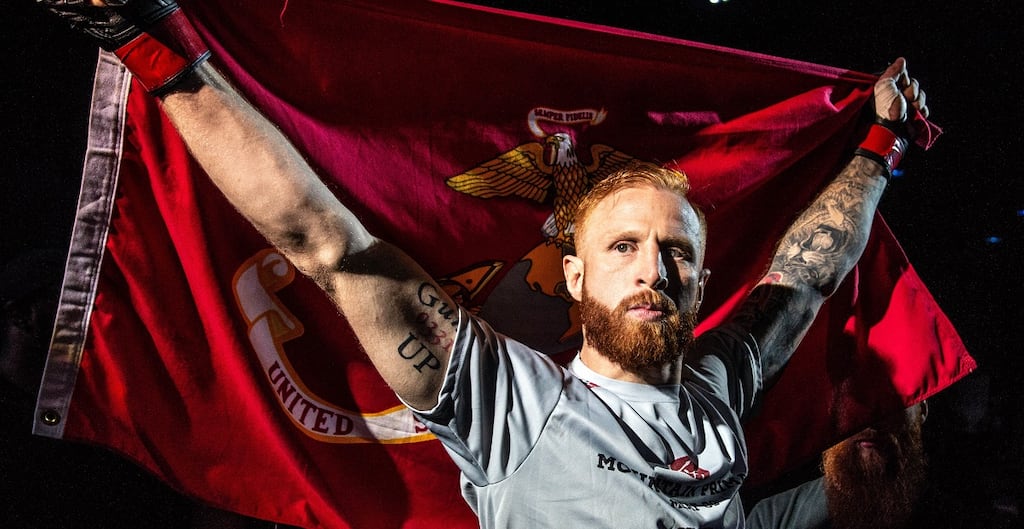 Kyle Stewart walks out at UFC Brooklyn carrying the United States Marine Corps flag